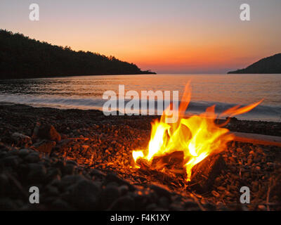 A driftwood fire on a Turkish beach, during a sea kayaking expedition Stock Photo