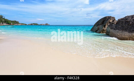 Beautiful landscape of blue sky sea sand and white waves on the beach during summer at Koh Miang island in Mu Ko Similan Stock Photo