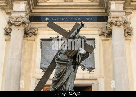 A statue of Jesus stands in front of Church of the Holy Cross Warsaw, Poland Stock Photo