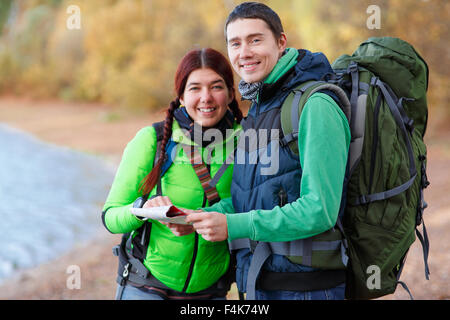 Happy couple going on a hike together in a forest Stock Photo