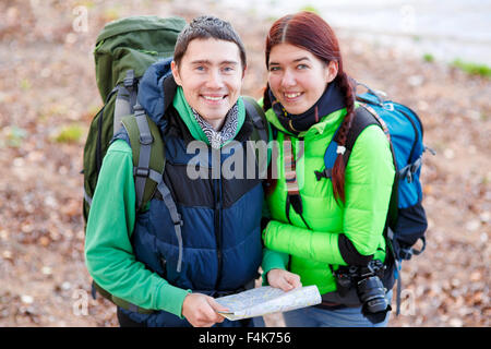 Happy couple going on a hike together in a forest Stock Photo