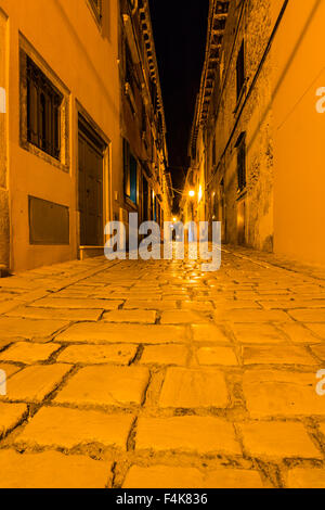 Narrow street in night of old town of Rovinj, Croatia Stock Photo