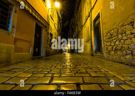 Narrow street in night of old town of Rovinj, Croatia Stock Photo