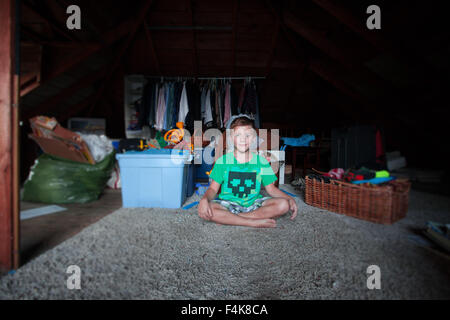 Two Twin Brothers play with one another in their family attic Stock Photo