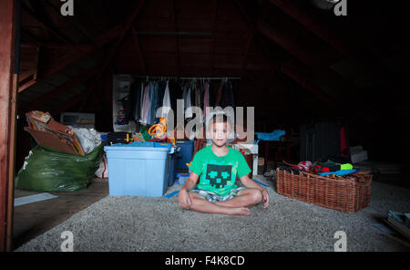 Two Twin Brothers play with one another in their family attic Stock Photo