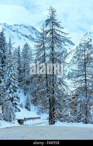 Winter snowy peaceful Samnaun Alps landscape and country road with barrier (Swiss). Stock Photo