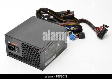 Be Quiet 550 watt computer PSU power supply unit and connecting power cables. Stock Photo