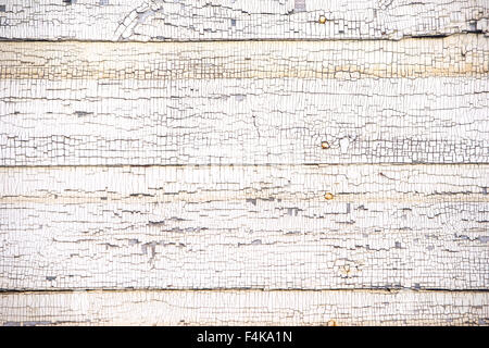 Detail of white paint peeling from a wooden wall Stock Photo