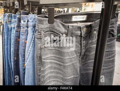 A rack of Madewell brand jeans outside of a recycling event at a Madewell store in New York on Friday, October 9, 2015. Madewell is collecting old denim to be recycled and turned into environmentally friendly insulation offering $20 off a new pair of jeans. Madewell is a brand of J.Crew. © Richard B. Levine) Stock Photo