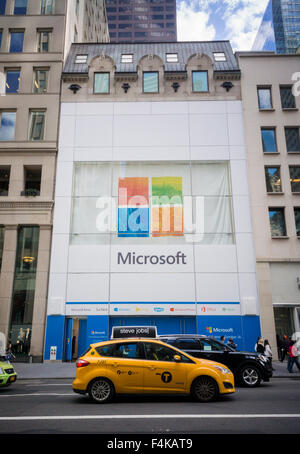 A taxi advertising the recently opened Steve Jobs film passes the soon to be opened flagship Microsoft store on Fifth Avenue, seen on Friday, October 16, 2015. The store is scheduled to open on October 26.(© Richard B. Levine) Stock Photo