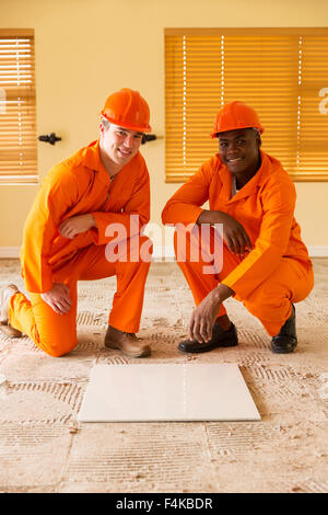 professional construction co-workers doing renovations inside house Stock Photo