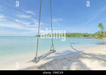 Summer, Travel, Vacation and Holiday concept - Swing hang from coconut palm tree over beach sea in Phuket ,Thailand. Stock Photo