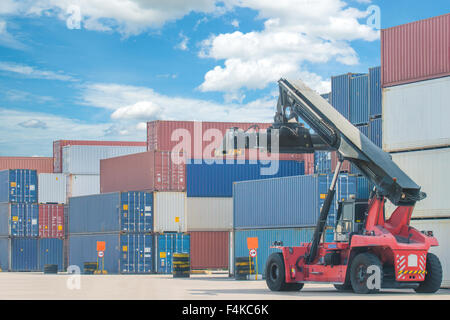 forklift handling container box loading to truck in import export logistic zone Stock Photo