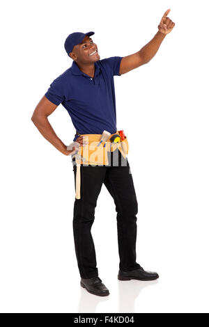happy young African American handyman pointing at empty space Stock Photo