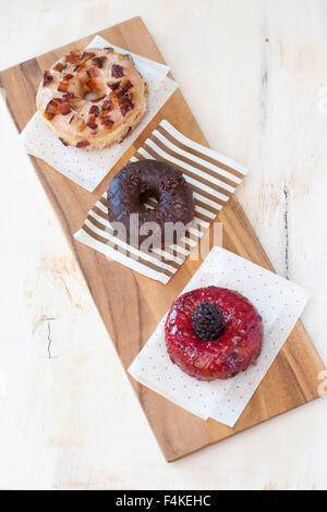 Overhead trio shot of gourmet donuts Stock Photo