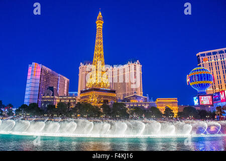 Night view of the dancing fountains of Bellagio and the Eiffel Tower replica of Paris hotel in Las Vegas Stock Photo