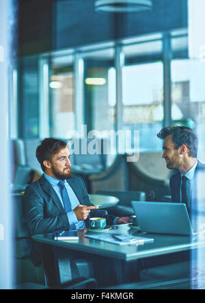 Two confident managers sharing ideas in cafe Stock Photo