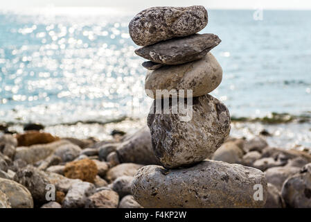 Art of stone balance, piles of stones on the beach. Ibiza, Spain Stock Photo