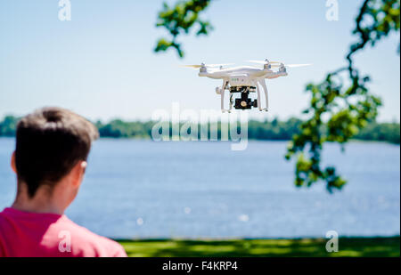 Quadrocopter with photo camera flying outdoors Stock Photo