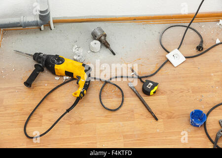 Place of electric socket repair process with drill Stock Photo