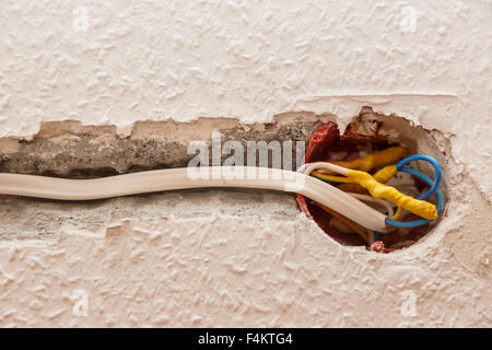 Electricity socket installation on white wall closeup Stock Photo