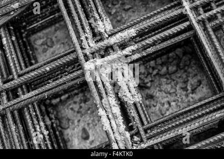 Splashes of concrete on pile of rebar Stock Photo