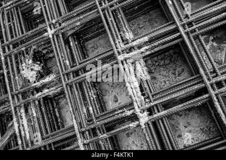 Splashes of concrete on pile of rebar Stock Photo