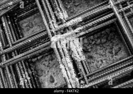 Splashes of concrete on pile of rebar Stock Photo