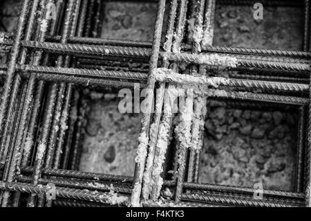 Splashes of concrete on pile of rebar Stock Photo