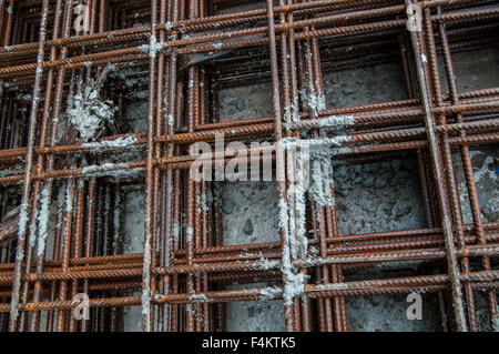 Splashes of concrete on pile of rebar Stock Photo