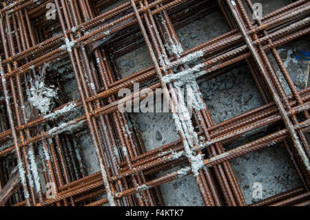 Splashes of concrete on pile of rebar Stock Photo