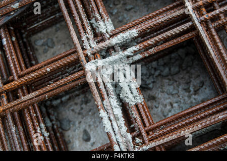 Splashes of concrete on pile of rebar Stock Photo