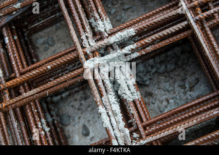 Splashes of concrete on pile of rebar Stock Photo