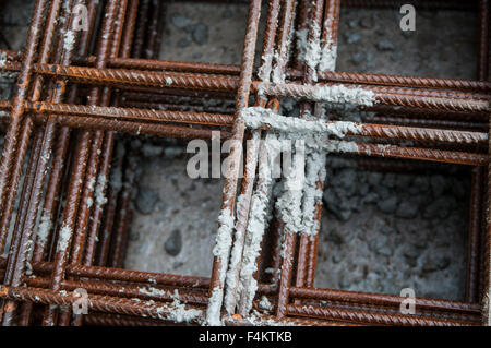 Splashes of concrete on pile of rebar Stock Photo