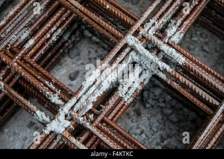 Splashes of concrete on pile of rebar Stock Photo