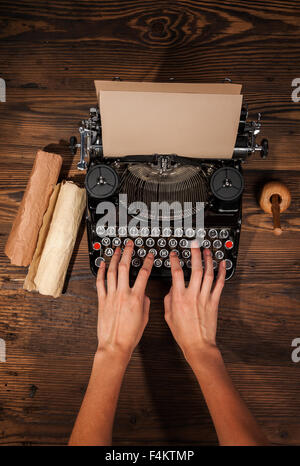 Woman typing on an old typewriter Stock Photo