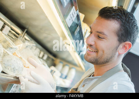 Gloved man at cold counter Stock Photo