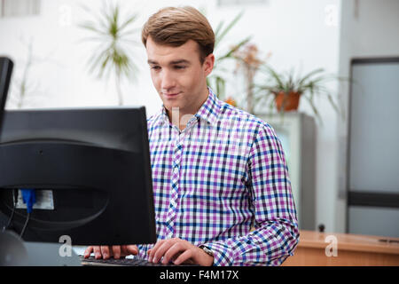 Portrait of a male student using computer in university Stock Photo