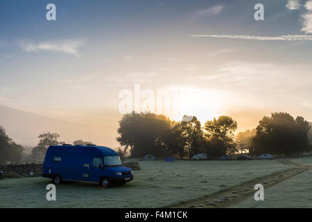 The Rising Sun Burning Through the Mist on a Frosty Morning at High Laning Farm Campsite Dent Dentdale Cumbria UK Stock Photo