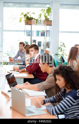 Portrait of a multi ethnic students studying in university library Stock Photo