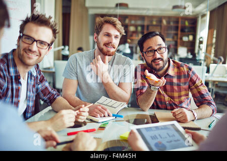 Businessmen consulting with each other at meeting Stock Photo