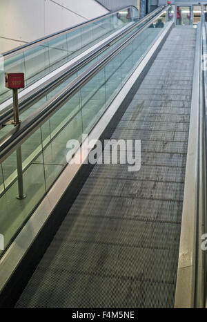 shopping center Step-less escalator with emergency stop button in red , Empty escalator perspective from down to up, Stock Photo