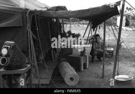 Soldiers at a First Infantry Division base camp in 1965 during the Vietnam War. Stock Photo