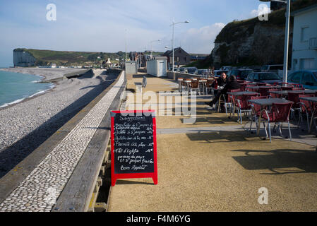 Empty restaurant tables on promenade next to sea, Veulettes-sur-Mer, Normandy, France Stock Photo