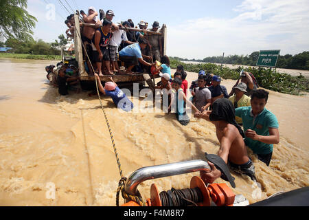 (151020) -- PAMPANGA PROVINCE, Oct. 20, 2015 (Xinhua) -- Residents try to board a truck to avoid a flooded road due to Typhoon Koppu in Pampanga Province, the Philippines, Oct. 20, 2015. (Xinhua/Stringer) Stock Photo