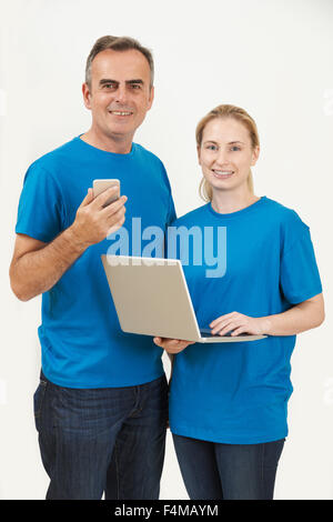 Studio Portrait Of IT Support Staff Wearing Uniform Against White Background Stock Photo