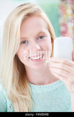Teenage Girl Taking Selfie On Mobile Phone Stock Photo