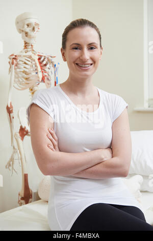 Portrait Of Female Osteopath In Consulting Room Stock Photo