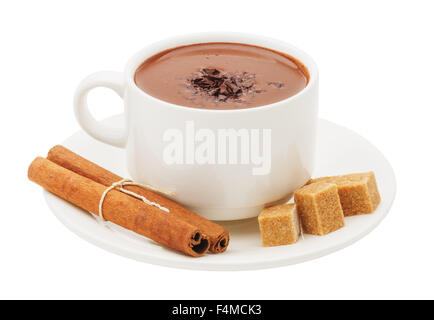 A cup of hot chocolate, cinnamon sticks and cubes of cane sugar on saucer close-up isolated on white background Stock Photo