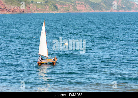 Small catamaran sailing boat leaving Babbacombe Beach and entering Torbay on sunny September day in Torquay, Devon, England Stock Photo
